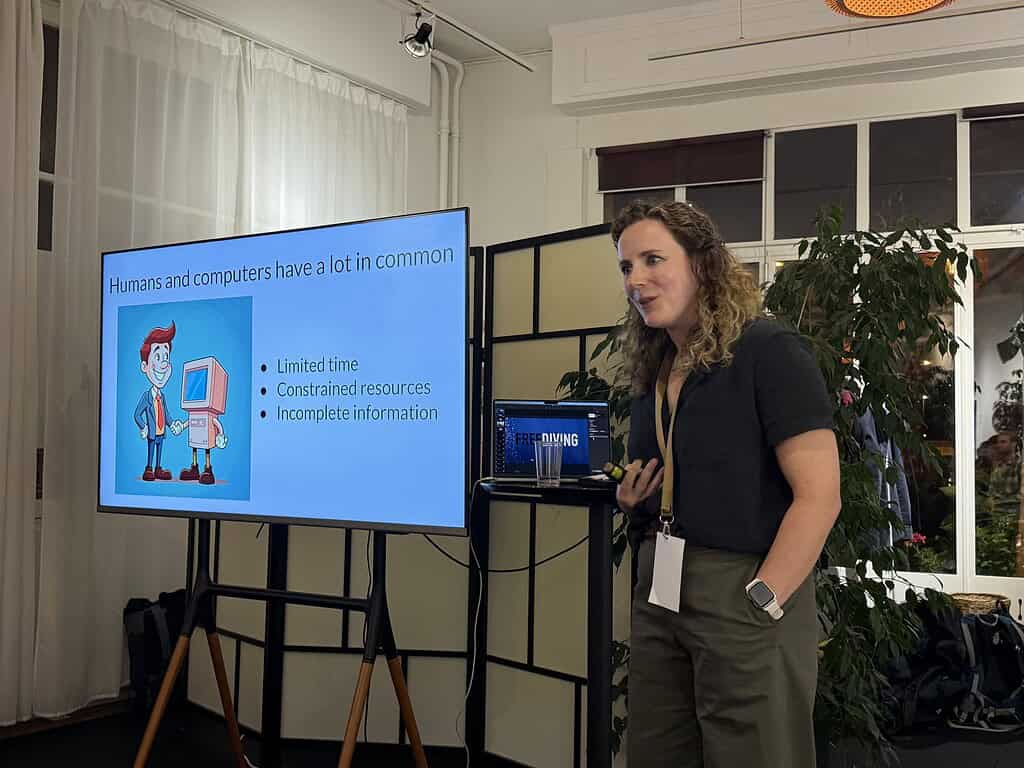 Woman presenting on the similarities between humans and computers at Coffeehouse Conference.