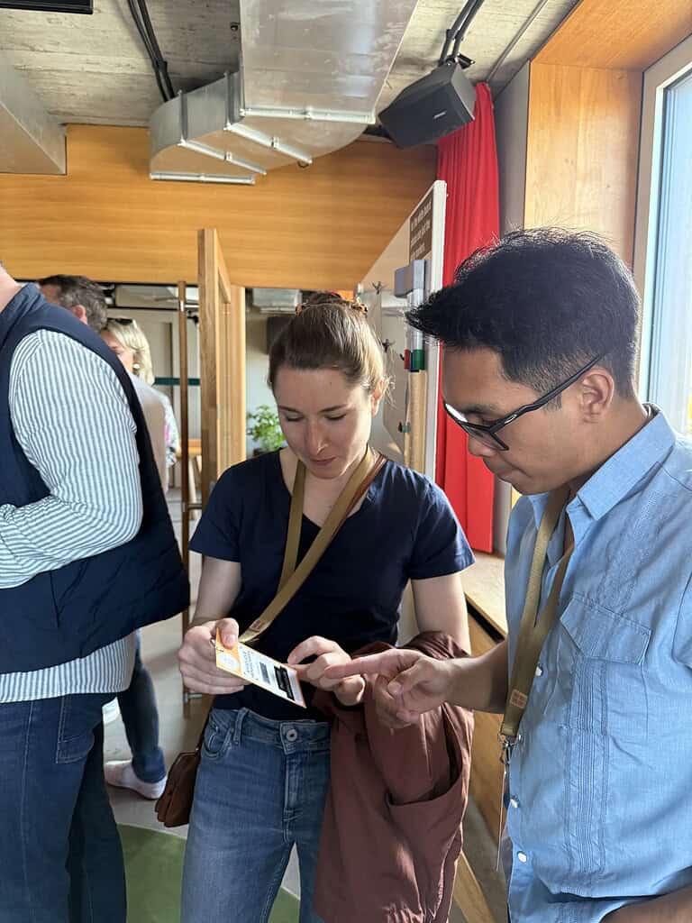 Attendees at Coffeehouse Conference using smartphones to network and share ideas.