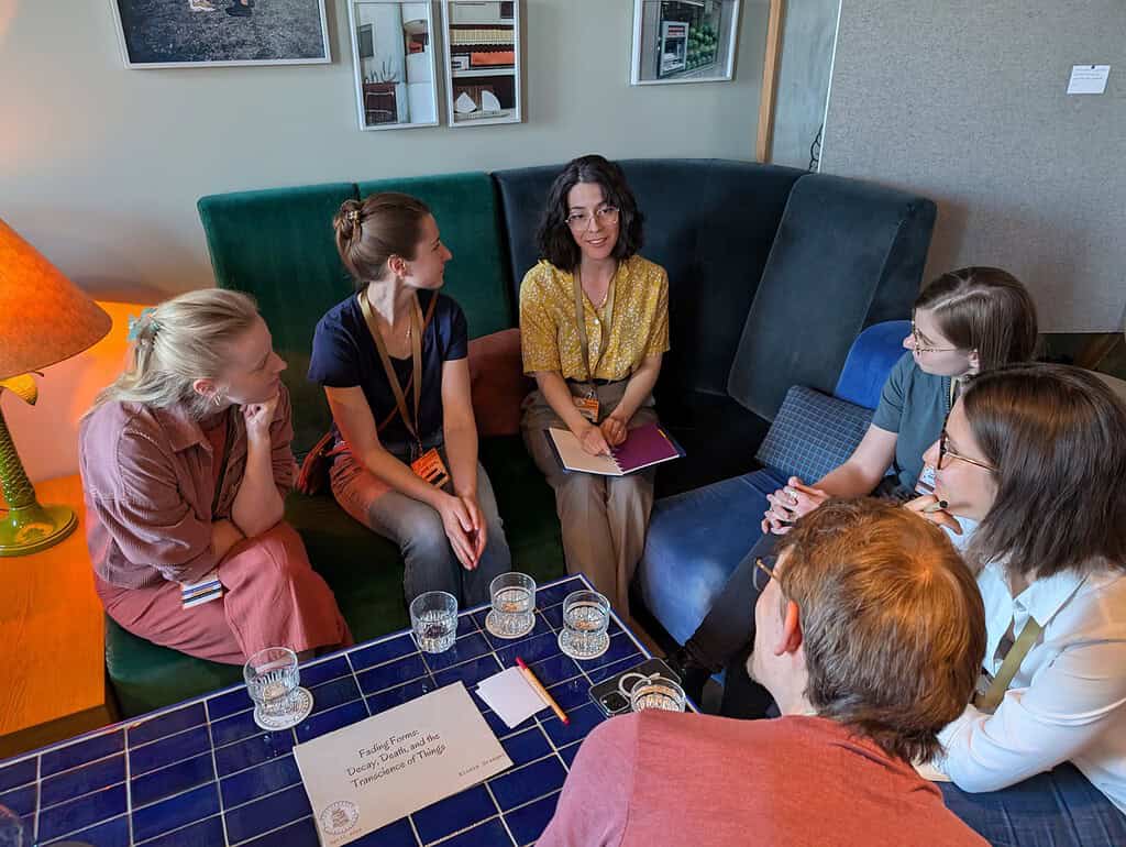 Group of diverse women engaged in a lively discussion at the Coffeehouse Conference.