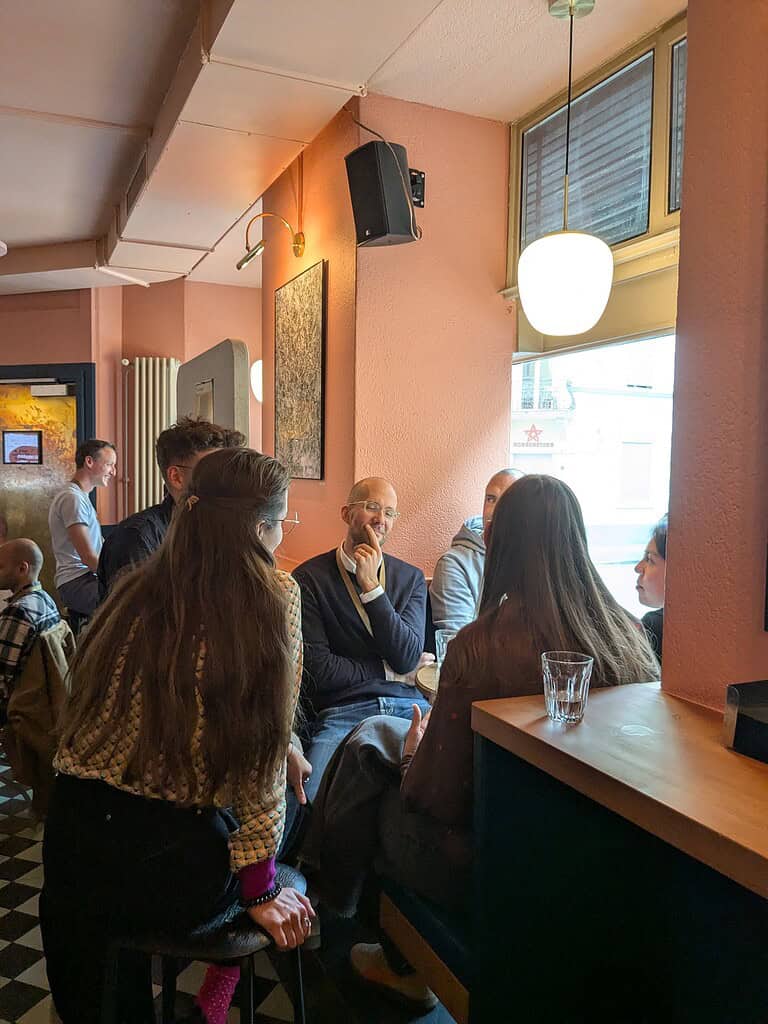 People engaging in conversation at the Coffeehouse Conference event.